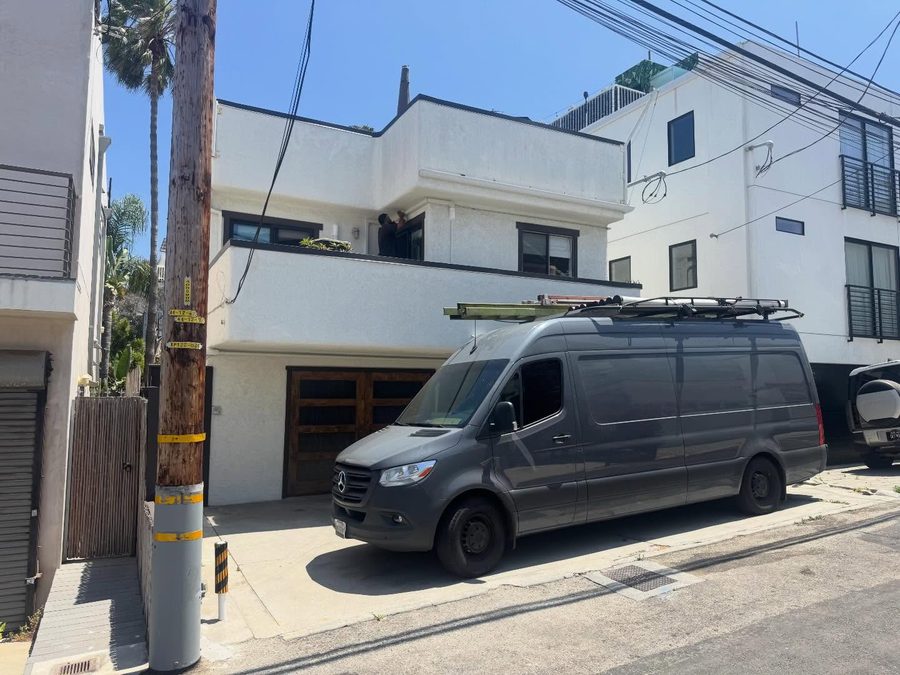 310 HVAC work van with ladder rack parked at a two-story install job in Venice